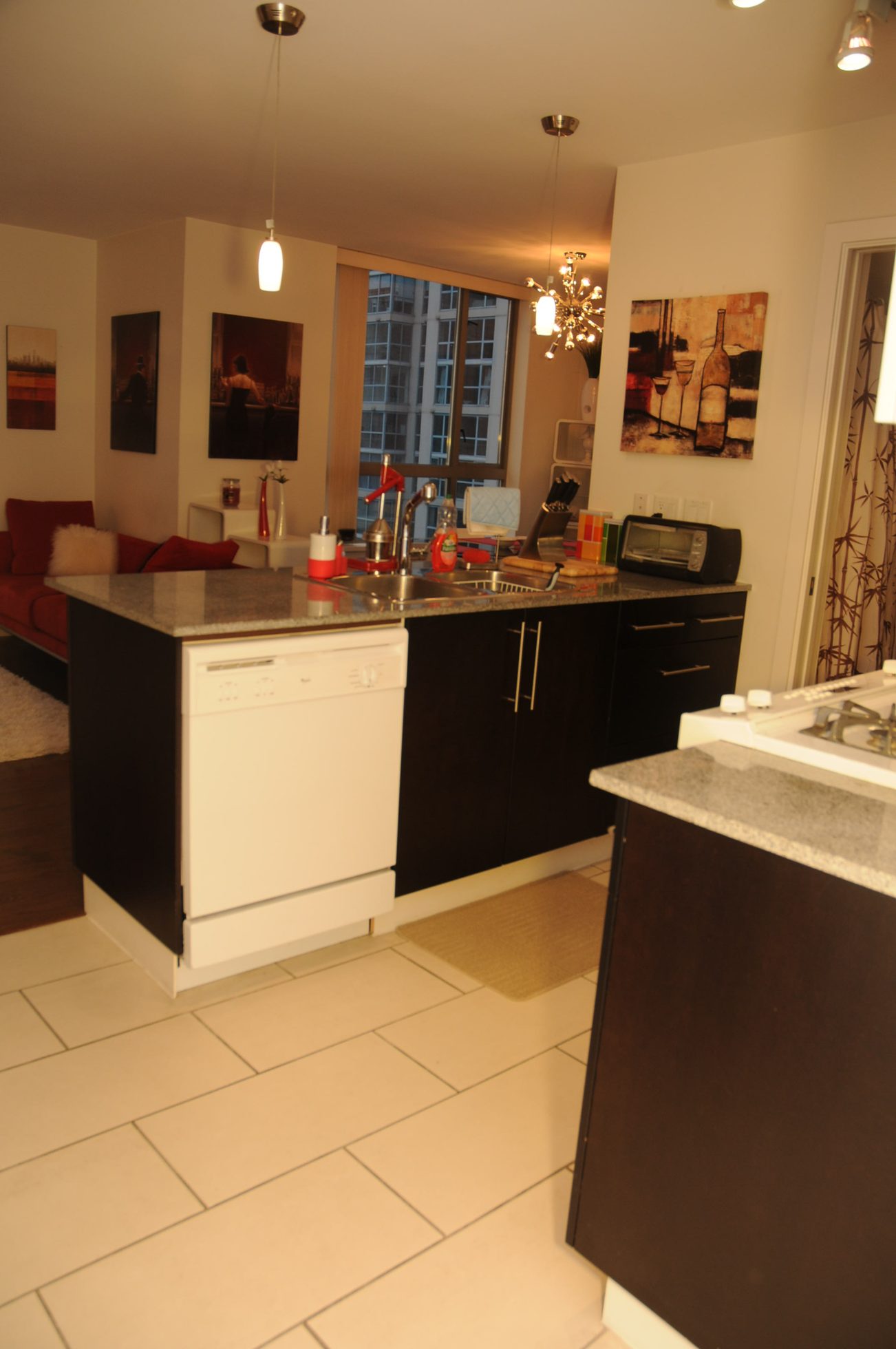 Bright kitchen with granite countertops, black cabinets, and a city view. - 1808 - 1225 Richards Street, Vancouver Downtown