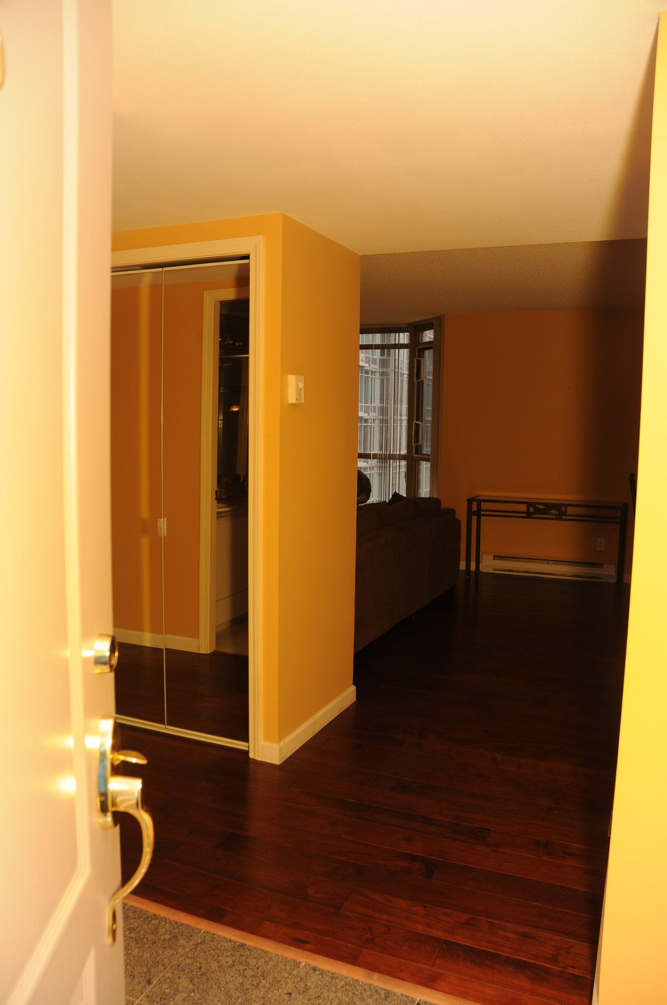 Living room with hardwood floors and a sliding door leading to another room. - 1705-867 Hamilton Street, Vancouver Downtown