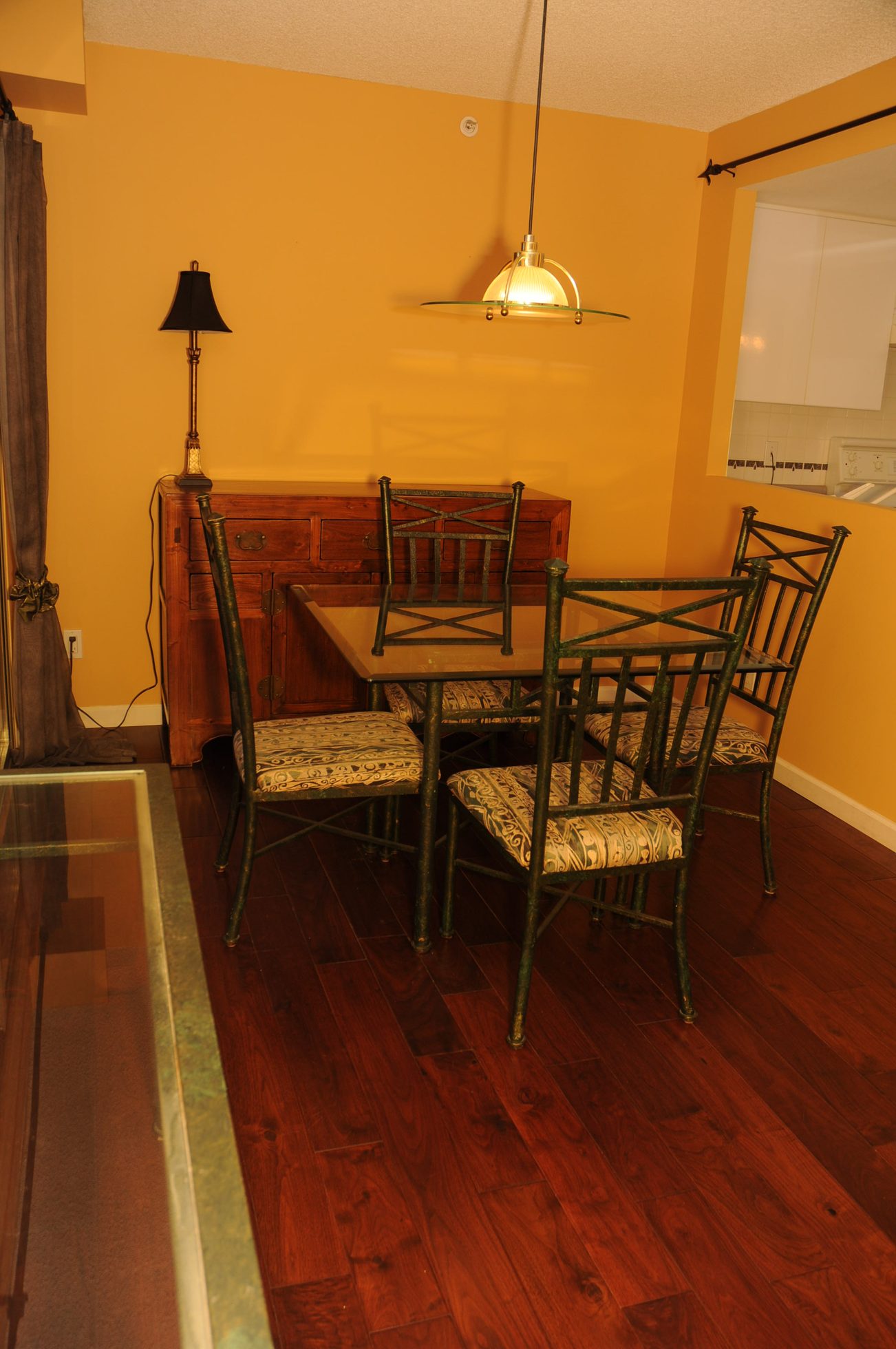 Furnished dining area with hardwood floors and a wooden buffet. - 1705-867 Hamilton Street, Vancouver Downtown