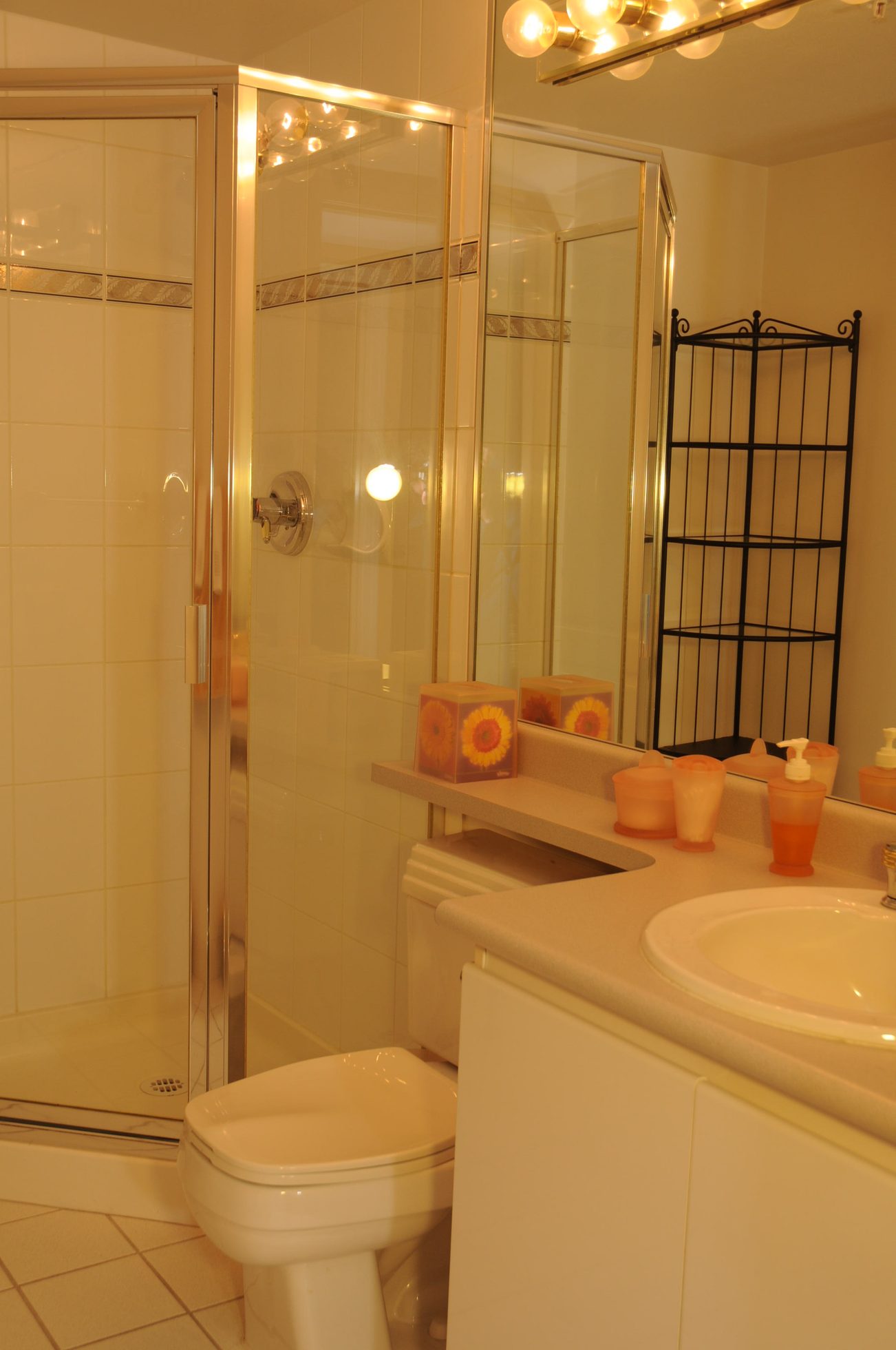Furnished bathroom with white countertop and orange accessories. - 1705-867 Hamilton Street, Vancouver Downtown