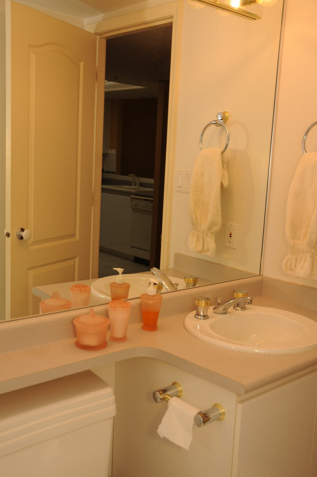 Furnished bathroom with white countertop and orange toiletries, reflected in mirror. - 1705-867 Hamilton Street, Vancouver Downtown