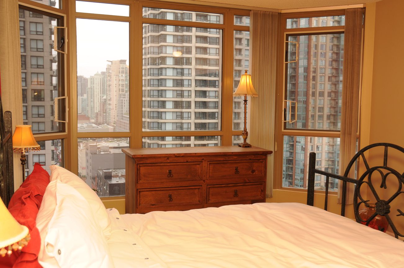Furnished bedroom with city view and wooden desk. - 1705-867 Hamilton Street, Vancouver Downtown