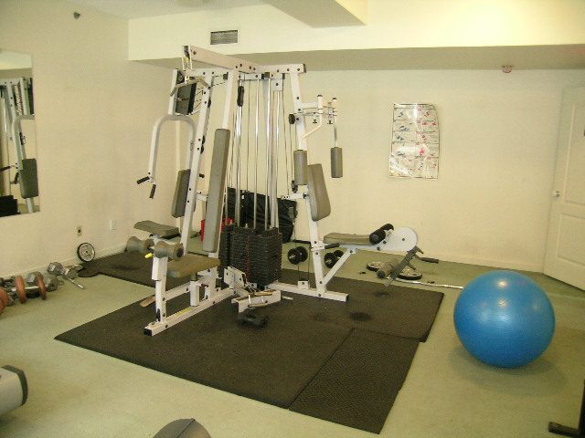 Bright gym with weight bench and exercise ball, clean and organized. - 1705-867 Hamilton Street, Vancouver Downtown