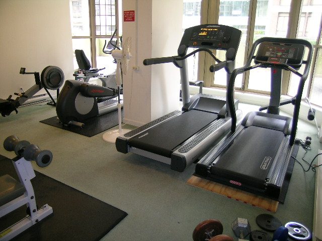 Fitness room with treadmills and dumbbells, large windows. - 1705-867 Hamilton Street, Vancouver Downtown