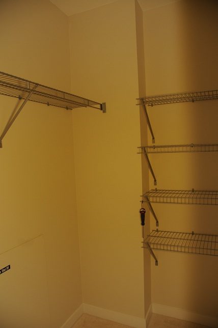 Empty closet with metal shelving and a small sign. - G07 - 119 West 22nd Avenue, North Vancouver