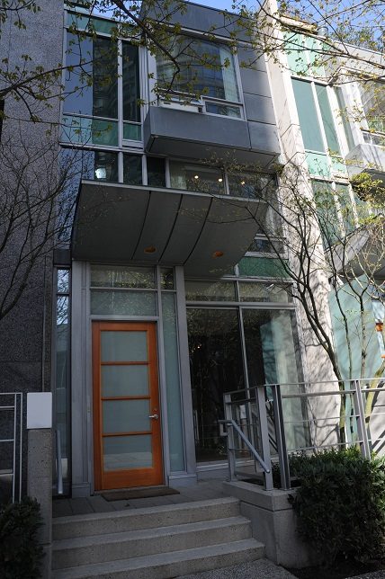 Modern townhouse entry with glass door and sleek metal awning. - 1275 Alberni Street, Vancouver Downtown