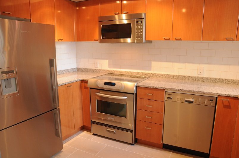 Bright kitchen with granite countertops, stainless steel appliances, and wooden cabinets. - 1275 Alberni Street, Vancouver Downtown