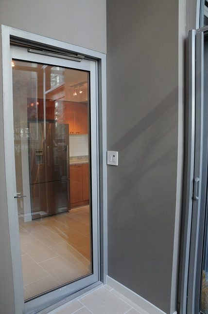 Bright kitchen with stainless steel appliances and wooden cabinets. - 1275 Alberni Street, Vancouver Downtown