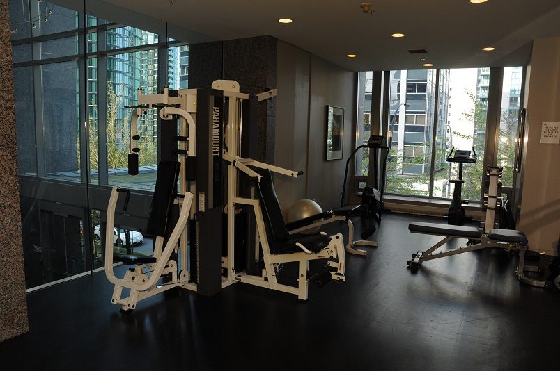 Bright and modern gym with large windows, city view, and various workout equipment. - 1275 Alberni Street, Vancouver Downtown