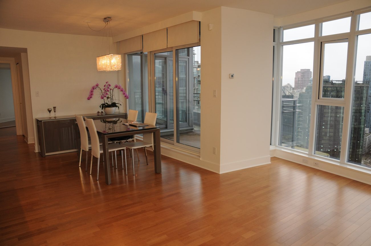 Bright dining area with hardwood floors, city view, and modern decor. - 2901 - 1205 West Hastings Street, Vancouver Downtown