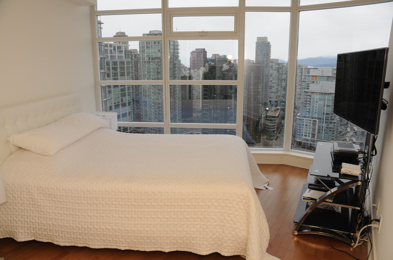 Bright bedroom with city view and hardwood floors. - 2901 - 1205 West Hastings Street, Vancouver Downtown