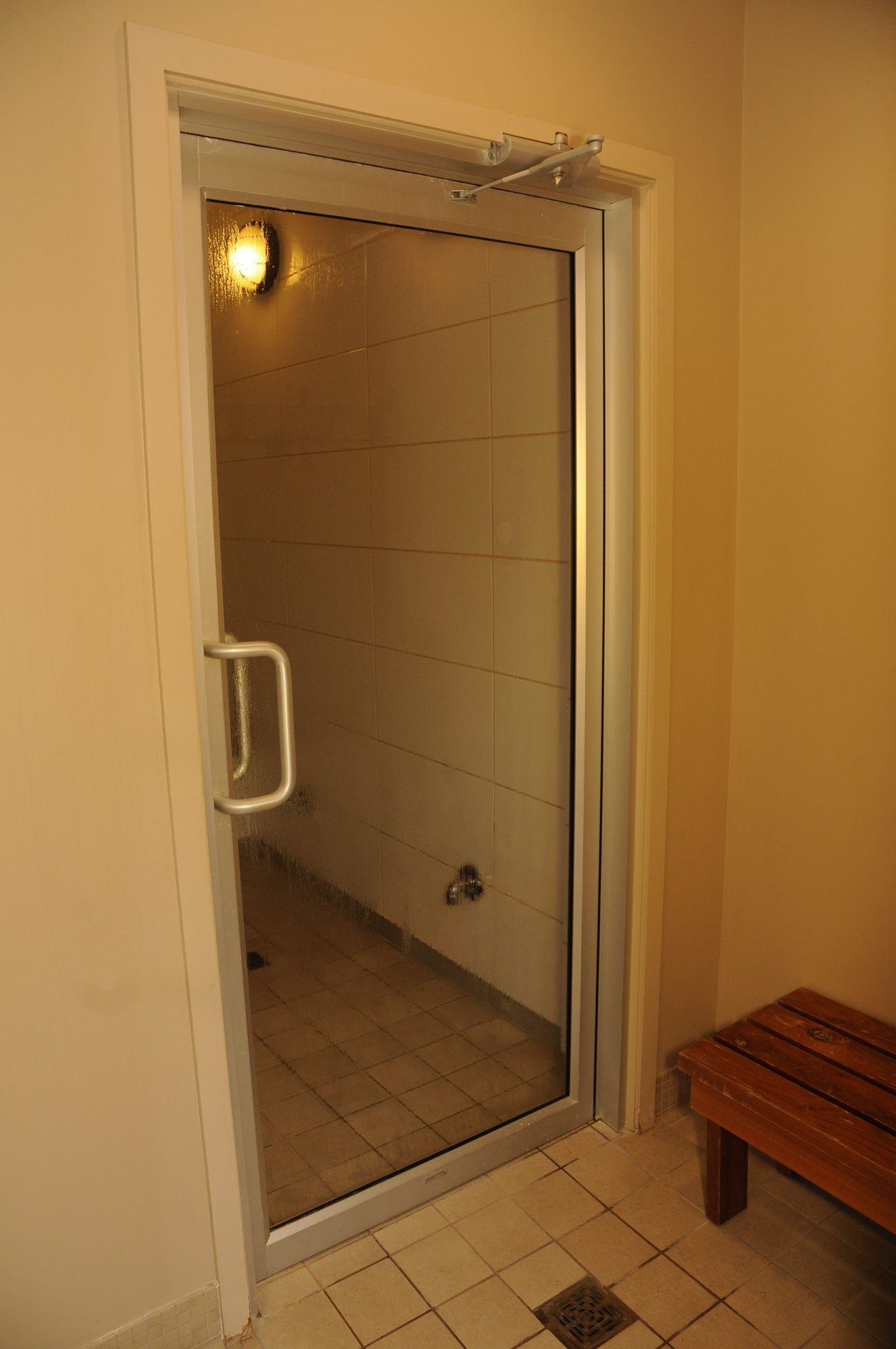 Shower with frosted glass door, bench nearby. - 2901 - 1205 West Hastings Street, Vancouver Downtown