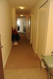 Furnished hallway leading to bedrooms, carpeted floor, small table with flowers. - 2006 - 918 Cooperage Way, Vancouver Downtown