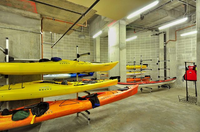 Storage room with kayaks and paddles, concrete walls, industrial lighting. - 2006 - 918 Cooperage Way, Vancouver Downtown