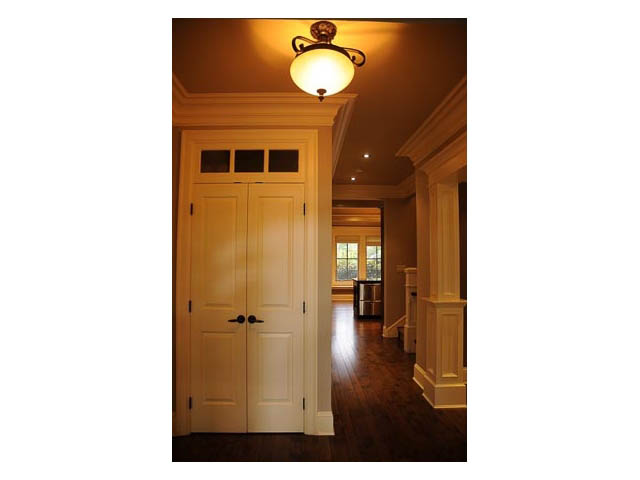 Foyer with hardwood floors, white paneled doors, and a warm ceiling light. - 3570 West 42nd Avenue, Vancouver West Side
