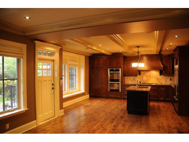 Bright kitchen with hardwood floors, dark wood cabinets, and a central island. - 3570 West 42nd Avenue, Vancouver West Side