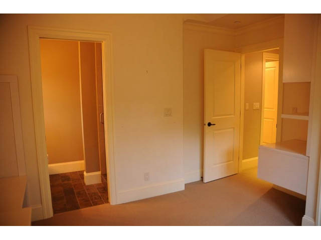 Bright bedroom with white walls, carpeted floor, and open door leading to another room. - 3570 West 42nd Avenue, Vancouver West Side