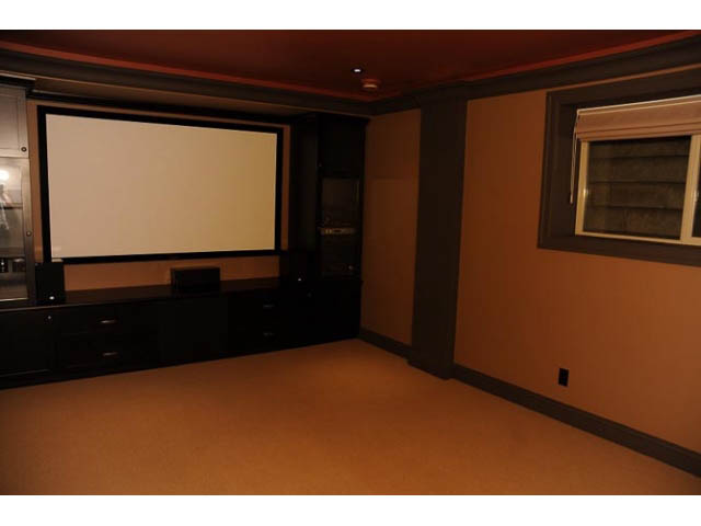 Home theater with large screen, dark walls, and built-in seating. - 3570 West 42nd Avenue, Vancouver West Side