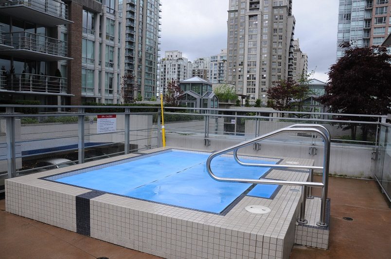 Outdoor pool with city views and modern building backdrop. - 1405- 565 Smithe Street, Vancouver Downtown