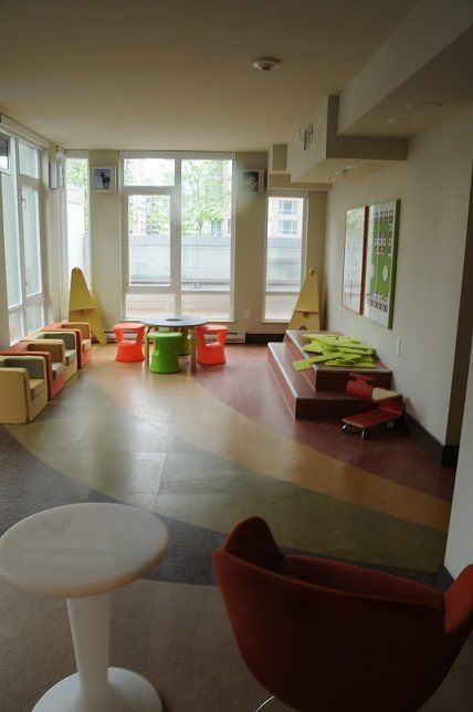 Bright living room with colorful furniture and large windows. - 1405- 565 Smithe Street, Vancouver Downtown