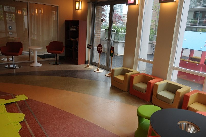 Living room with colorful furniture and large windows, showcasing a modern and inviting space. - 1405- 565 Smithe Street, Vancouver Downtown