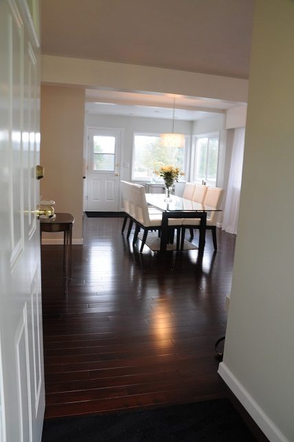 Elegant dining room with dark hardwood floors and a glass-top table. - 864 Fairway Drive, North Vancouver