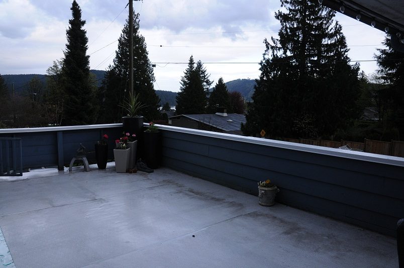 Deck with potted plants and a view of trees and rooftops. - 864 Fairway Drive, North Vancouver