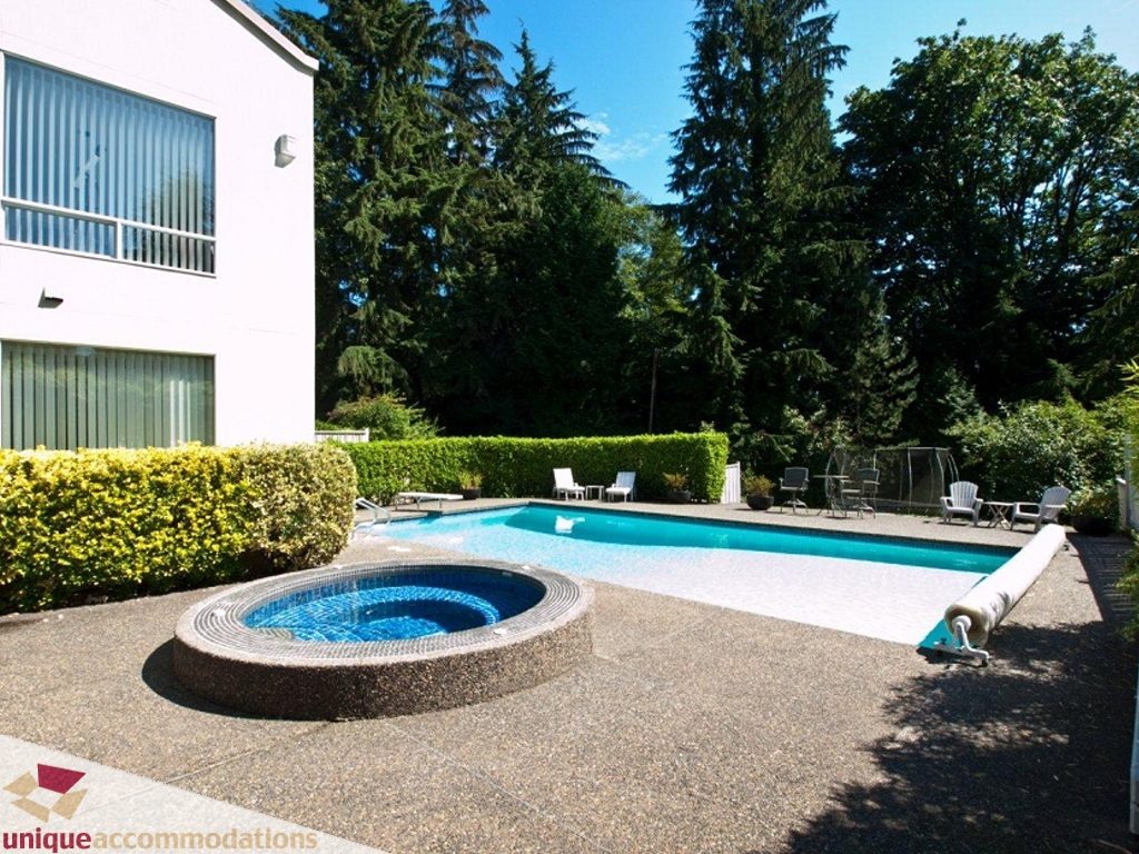 Furnished living room with a cozy fireplace and large windows. - 750 Anderson Crescent, West Vancouver
