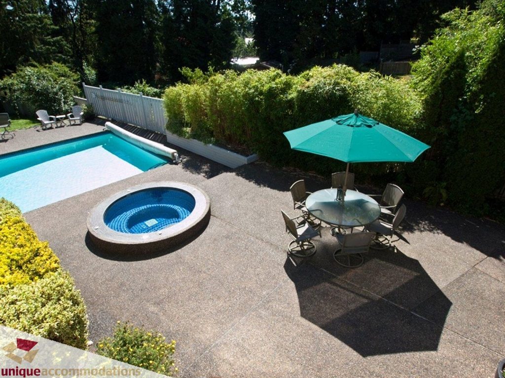 Furnished patio with a pool, lounge chairs, and umbrella. - 750 Anderson Crescent, West Vancouver