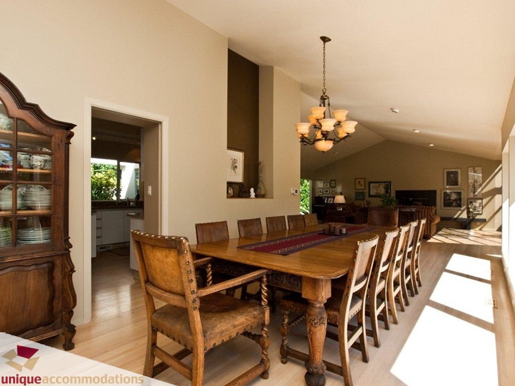 Furnished dining room with wooden table and chairs, hardwood floors, and a chandelier. - 750 Anderson Crescent, West Vancouver