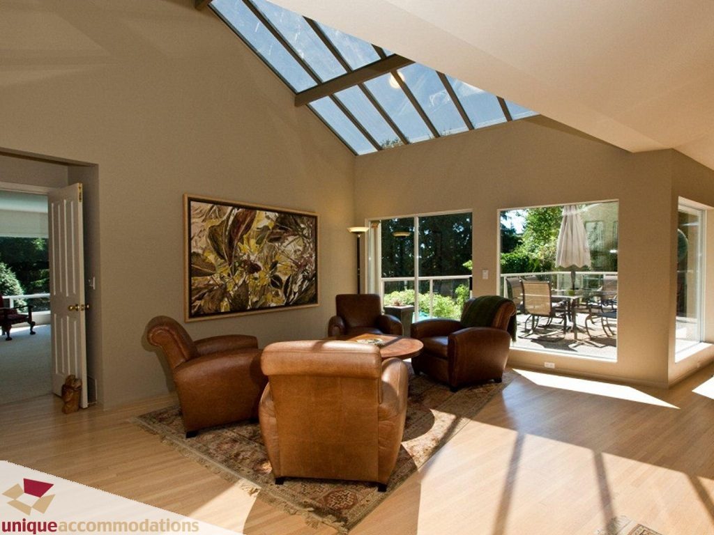 Furnished living room with hardwood floors, large windows, and a skylight. - 750 Anderson Crescent, West Vancouver