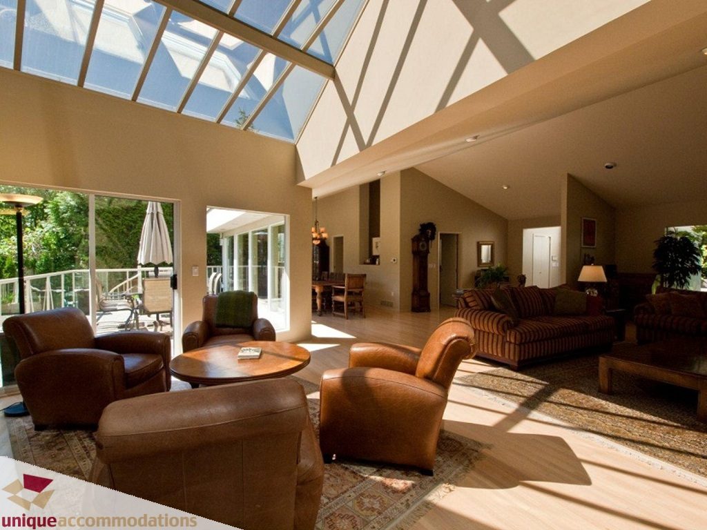 Spacious living room with high ceilings, skylights, and plush leather furniture. - 750 Anderson Crescent, West Vancouver