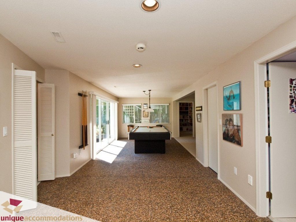 Bright living room with pool table, large windows, and artwork on walls. - 750 Anderson Crescent, West Vancouver