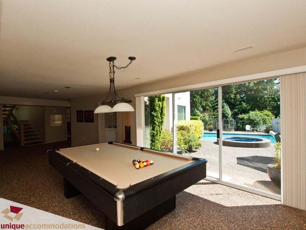 Spacious game room with pool table, sliding glass doors to outdoor pool and hot tub. - 750 Anderson Crescent, West Vancouver