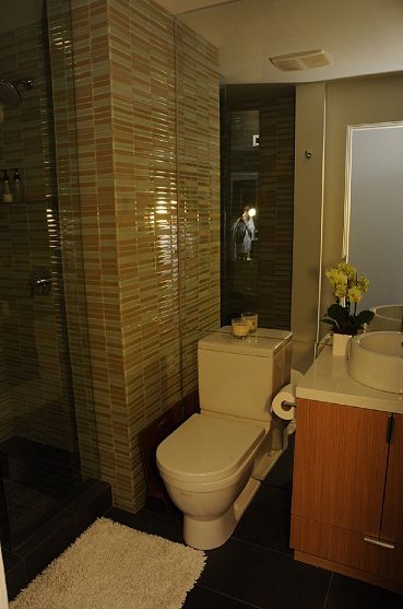 Modern bathroom with wooden cabinets and a glass shower. - 801-233 Abbott Street, Vancouver Downtown