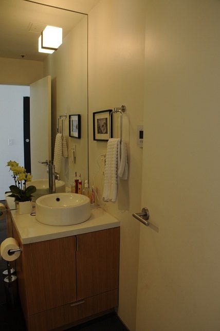 Furnished bathroom with white countertop and wooden cabinet. - 801-233 Abbott Street, Vancouver Downtown