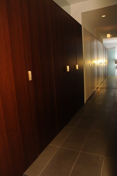 Furnished hallway with dark wood paneling and modern lighting fixtures. - 801-233 Abbott Street, Vancouver Downtown