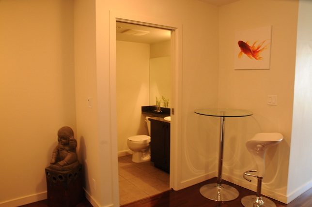 Furnished living room with hardwood floors and a glass coffee table. - 705 - 538 Smithe, Vancouver Downtown