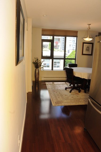 Bright dining area with hardwood floors, city view, and modern decor. - 705 - 538 Smithe, Vancouver Downtown