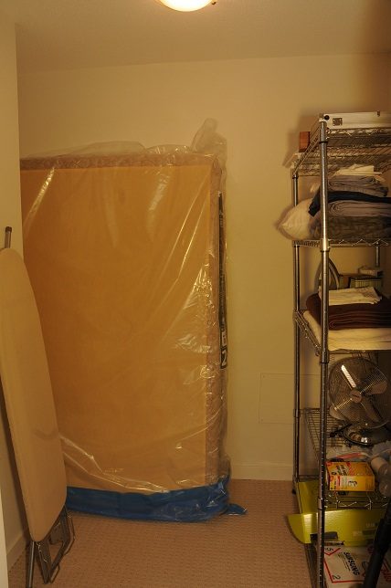 Storage area with plastic-wrapped furniture and shelving units. - 705 - 538 Smithe, Vancouver Downtown