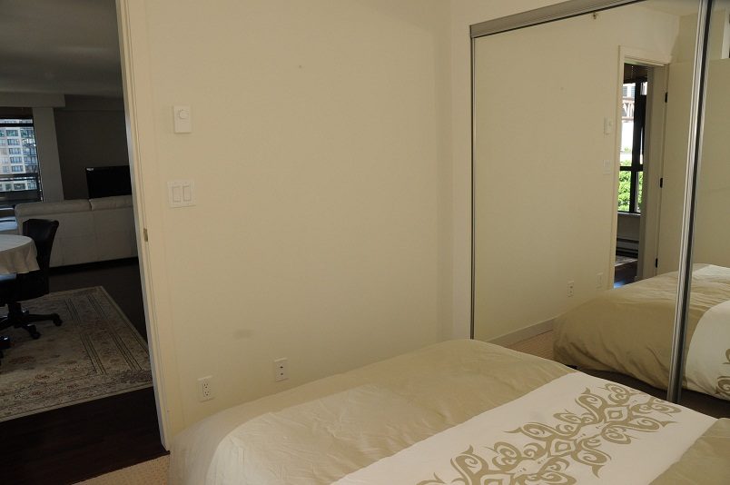 Furnished bedroom with mirrored closet and hardwood floors. - 705 - 538 Smithe, Vancouver Downtown