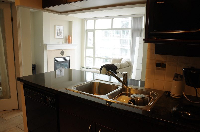 Bright kitchen with granite countertops, stainless steel sink, and city view. - 1607 - 1199 Marinaside Crescent, Vancouver Downtown