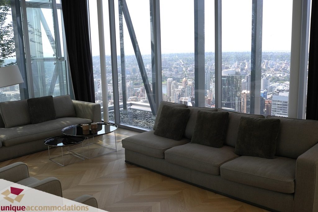 Furnished living room with hardwood floors and a stunning city view. - 6102-1128 West Georgia, Vancouver Downtown