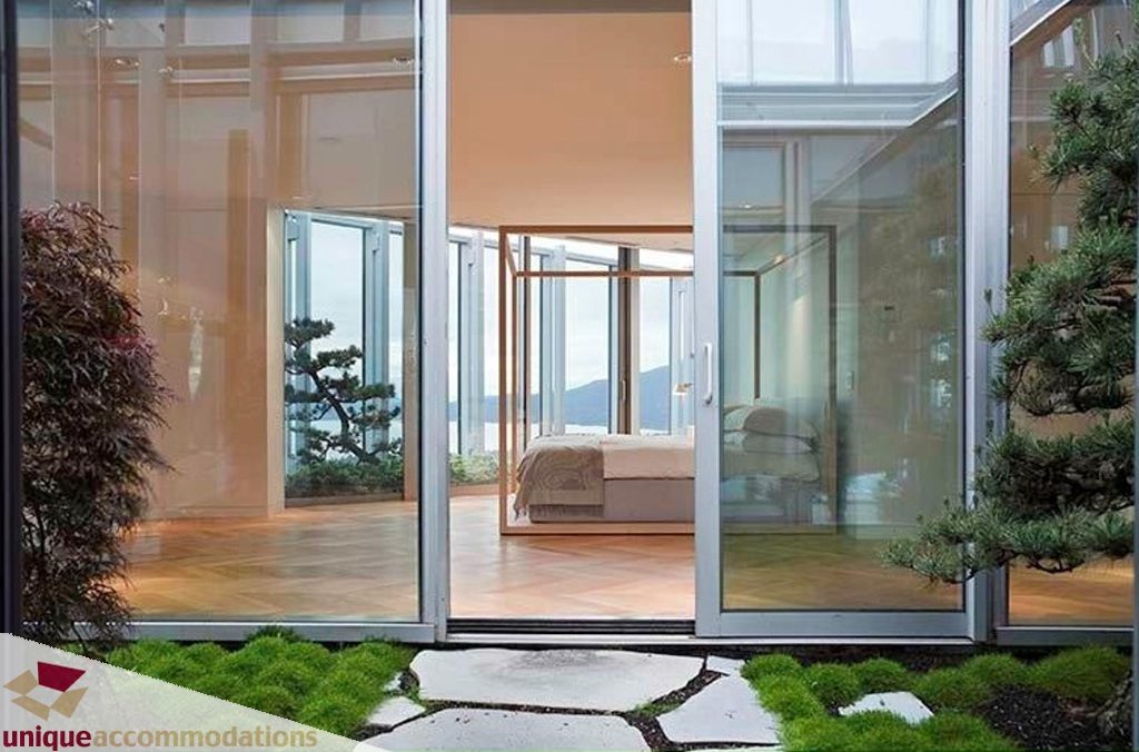 Spacious living room with large glass doors, hardwood floors, and city view. - 6102-1128 West Georgia, Vancouver Downtown