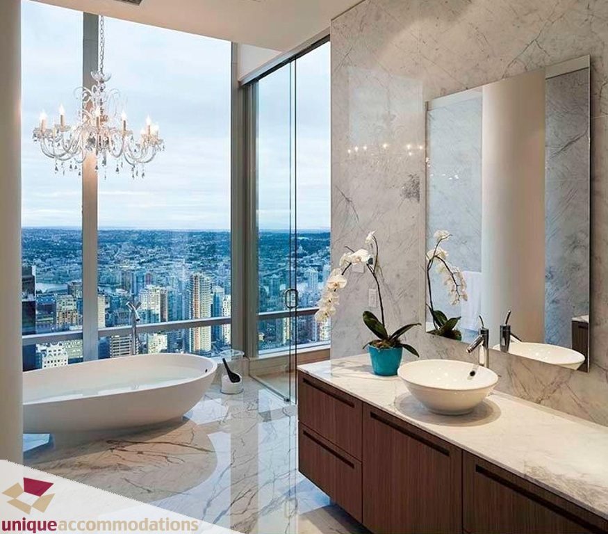 Luxurious bathroom with marble countertops, a freestanding tub, and a stunning city view. - 6102-1128 West Georgia, Vancouver Downtown