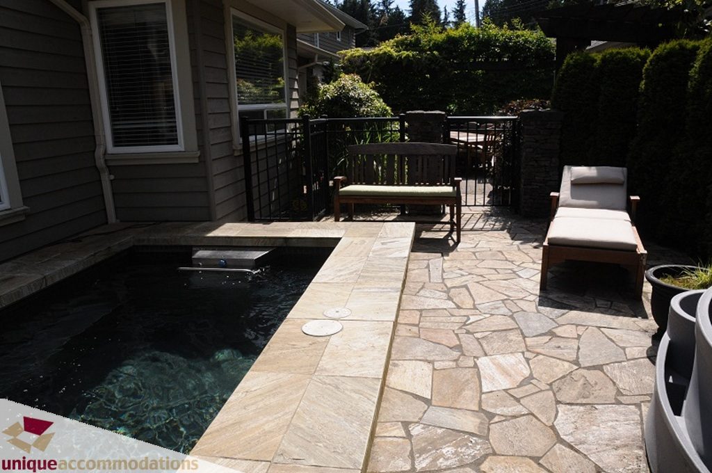 Spacious patio with stone flooring, outdoor seating, and a hot tub. - 3035 Newmarket Drive, North Vancouver