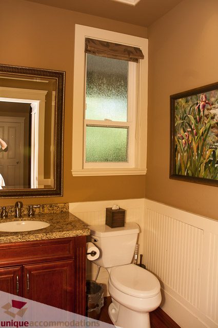 Furnished bathroom with granite countertops and wainscoting. - 3035 Newmarket Drive, North Vancouver