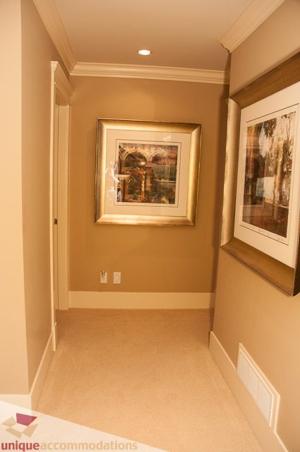 Foyer with framed artwork and built-in storage. - 3035 Newmarket Drive, North Vancouver