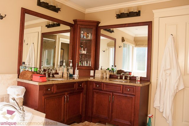 Spacious bathroom with large mirrors, granite countertops, and a view of the city. - 3035 Newmarket Drive, North Vancouver
