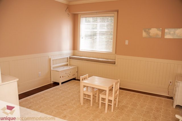 Bright dining area with wooden benches and patterned carpet. - 3035 Newmarket Drive, North Vancouver